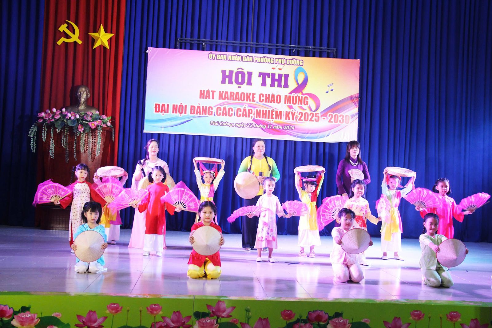 A group of children on a stageDescription automatically generated