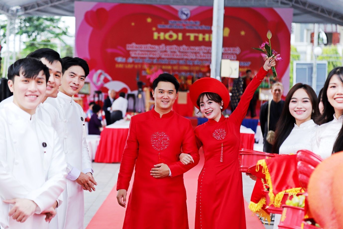 A group of people in red dressesDescription automatically generated