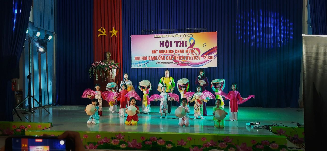 A group of children on a stageDescription automatically generated