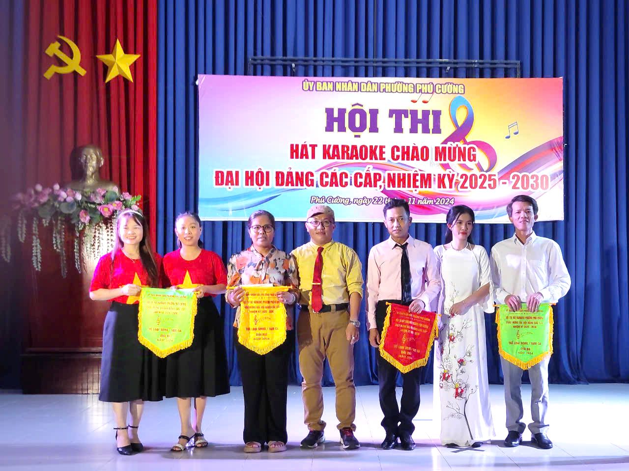 A group of people holding bannersDescription automatically generated